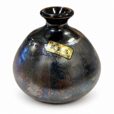 Front view of handcrafted Japanese Kouzan ceramic bud vase with dark metallic glaze and gold kiln label