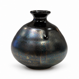 Side view of small Kouzan ceramic bud vase showing a black glaze trail and subtle metallic tones