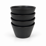 Stacked Japanese black ceramic tea cups showing their softly flared shape