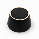 Underside of a Japanese black ceramic tea cup with an unglazed foot ring