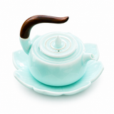 Celadon Qingbai porcelain teapot with lotus-shaped saucer and dark wooden handle