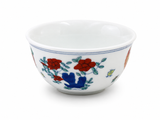 White ceramic tea cup showing the rooster and hen artwork inside