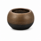 Open coarse pottery tea canister filled with loose black tea leaves, featuring a textured brown ceramic body on a white background.