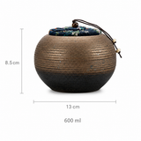 Coarse pottery tea canister with fabric lid, showing 8.5 cm height, 13 cm width, and 600 ml capacity on a white background.