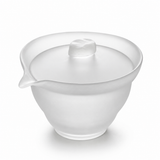 Frosted glass gaiwan with lid and spout on a clean white background, showing translucent matte glass texture and elegant tea brewing design.
