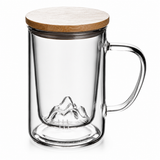 High-quality borosilicate glass brewing mug with bamboo and metal lid, clear handle, and mountain-shaped glass infuser detail.