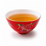 Red 80ml porcelain tea cup filled with tea, featuring butterfly floral design