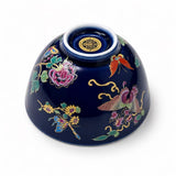 Porcelain gongfu tea cup bottom detail with colorful butterfly floral design