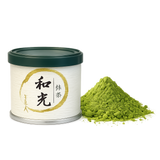 Wako Uji Matcha Japanese green tea powder tin with green lid and matcha powder beside it