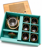 Tea set gift box with teapot, cups, and bamboo tray neatly arranged, premium packaging for elegant tea gift