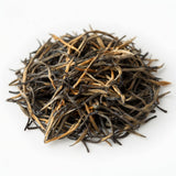 Loose Liu Xia ancient tree black tea leaves with golden tips on a white background
