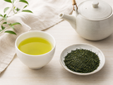 Cup of Shizuoka Fukamushi Sencha Japanese green tea with bright yellow-green liquor in a white teacup