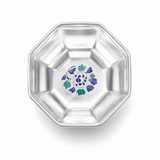 Top view of a silver-plated octagonal tea cup with a blue and teal floral motif inside.