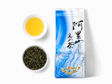 Loose Alishan oolong tea leaves beside brewed tea with package