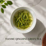 Brewed Tianmu Qingding green tea leaves in a white cup with fresh green tea color and natural light