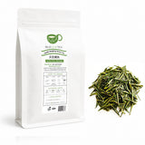 BESTLEAFTEA Tianmu Qingding green tea 100g bag with loose dry green tea leaves on a white background