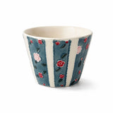 Ceramic coffee cup with blue vertical stripes and raised pink and red floral relief