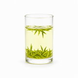 Zhu Ye Qing green tea brewed in a clear cylindrical glass with fresh green tea buds on a white background