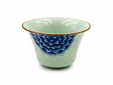 Celadon porcelain gaiwan bowl with blue floral motif and golden-brown rim