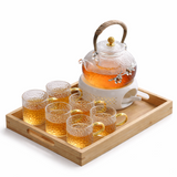 Japanese glass tea set with bamboo tray, warming base, and six glass cups